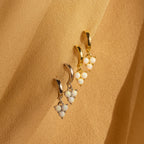 Two pairs of Opal Cluster Huggies in gold and silver, with clustered opal beads on a beige fabric background—perfect dainty hoop earrings for a unique bridesmaid gift.