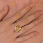 The Fingerprint Heart Necklace rests on a woman’s hand with nude nails—a meaningful memorial or thoughtful Mother’s Day gift.