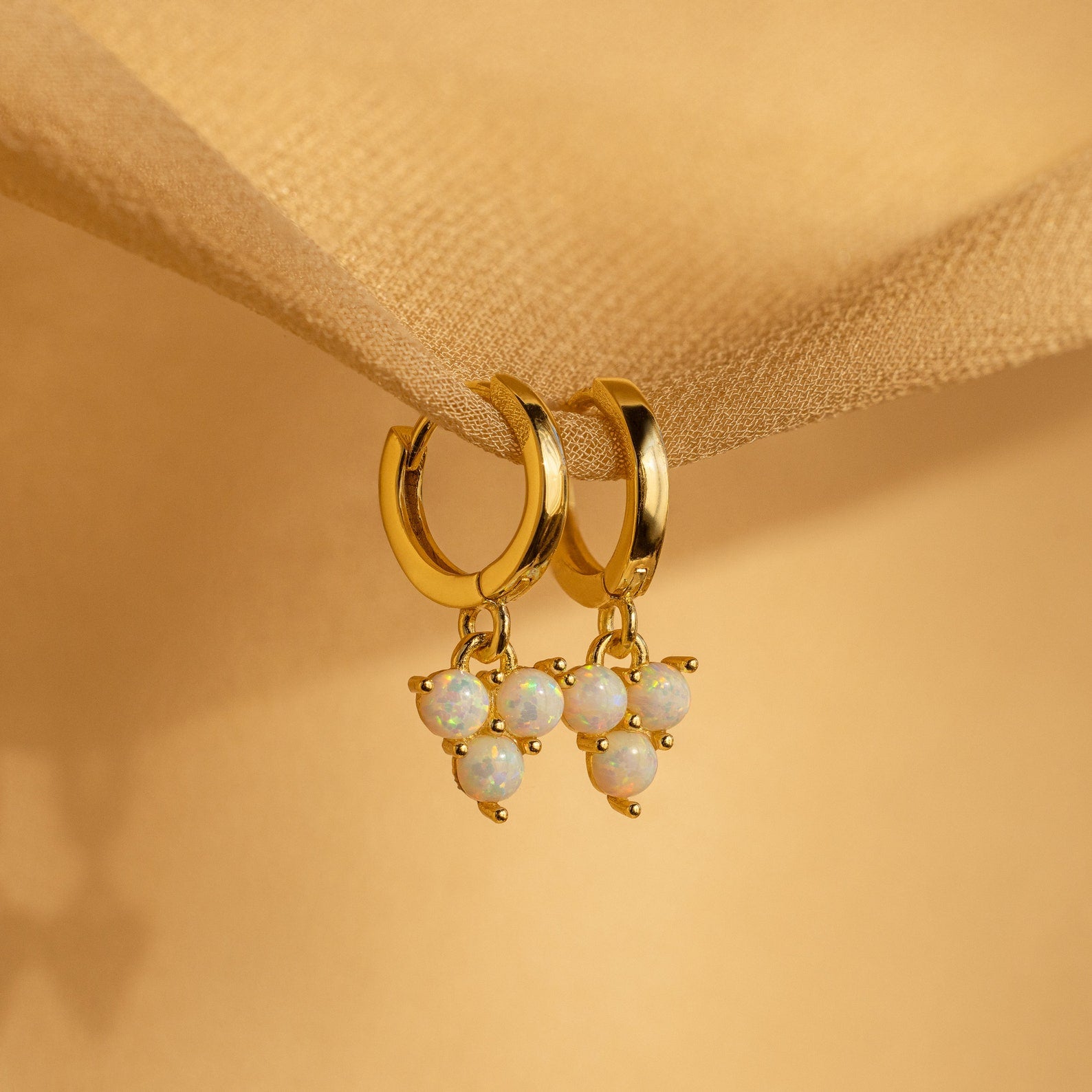 Opal Cluster Huggies with clusters of opal-like beads dangle elegantly—ideal as dainty hoop earrings or a thoughtful bridesmaid gift.