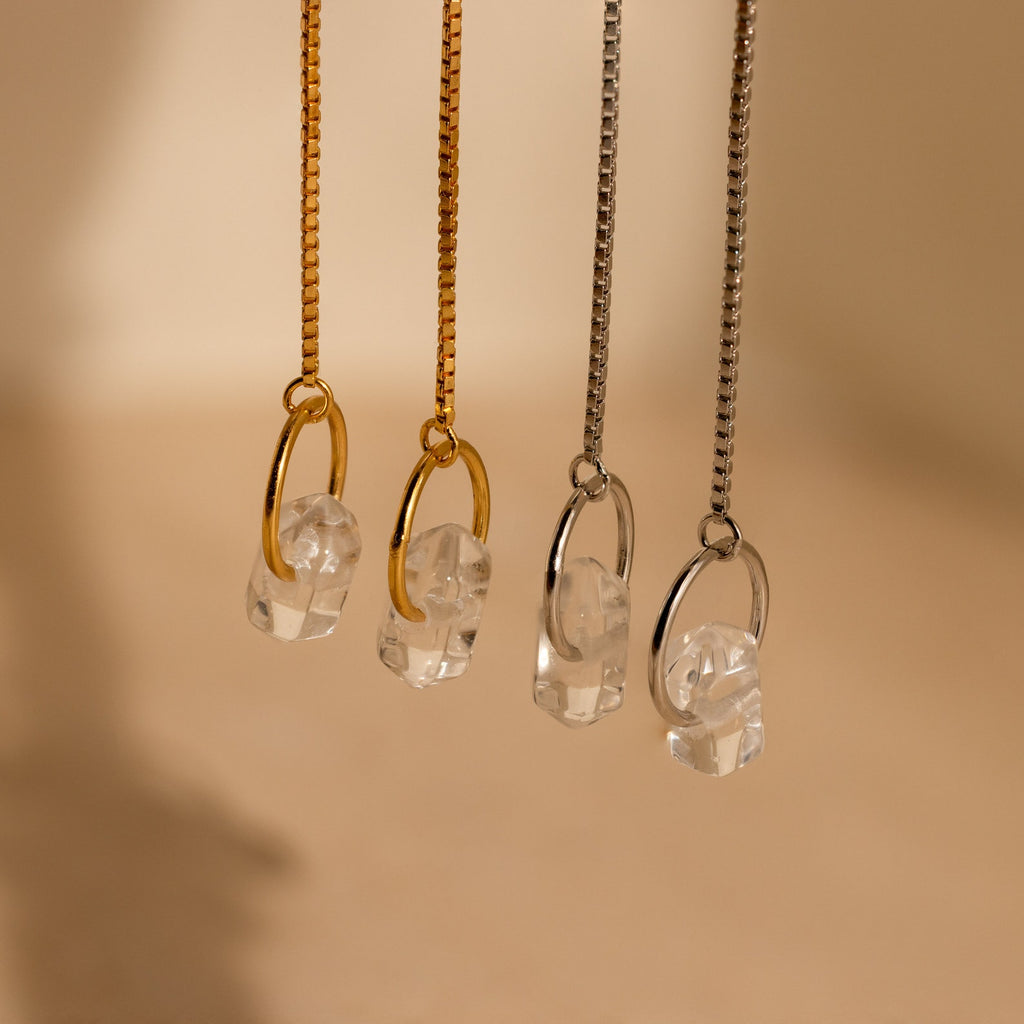 Two pairs of necklaces with clear crystal pendants—one on gold, one on silver chains—look stunning when paired with Herkimer Diamond Threader Earrings for a coordinated, elegant look.