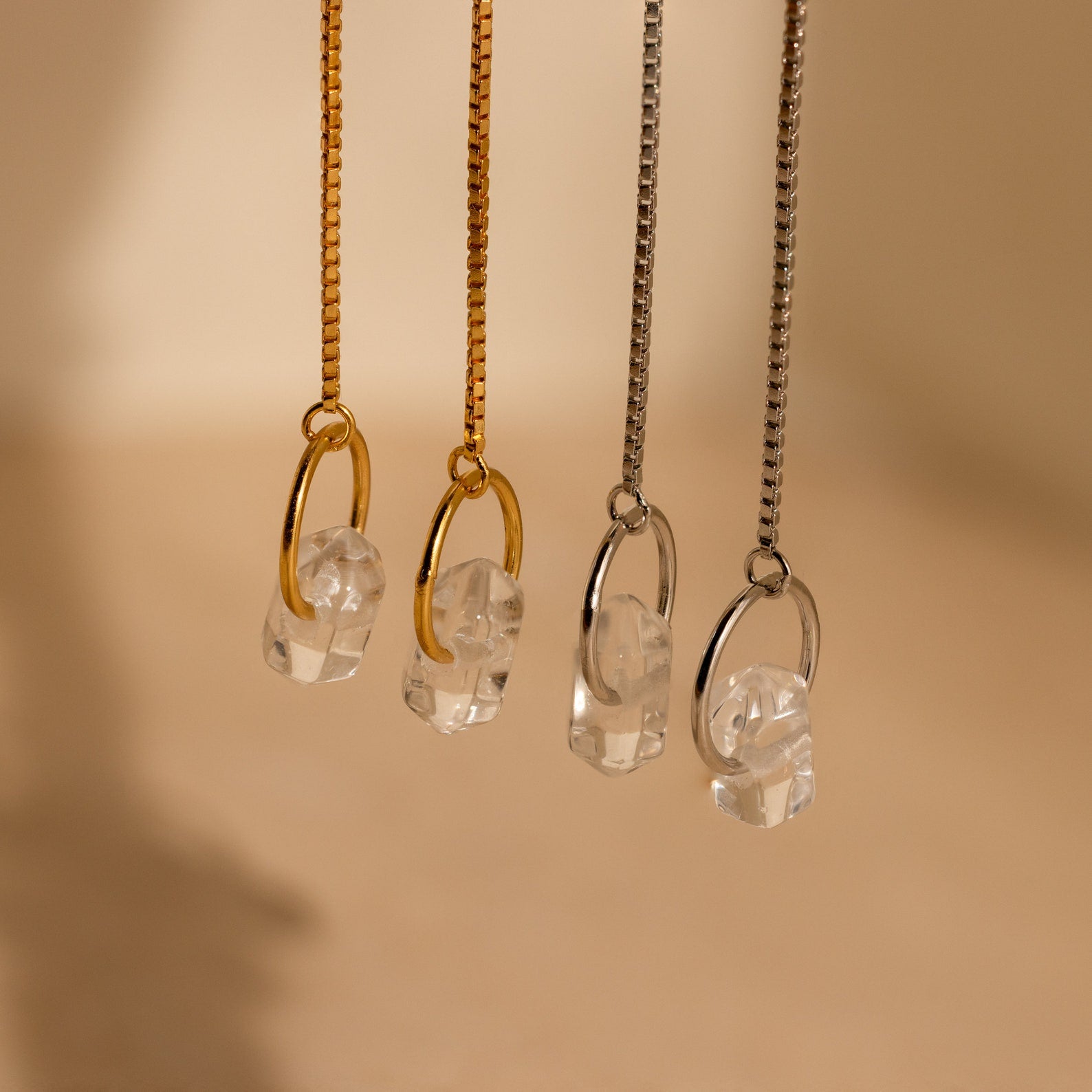 Two pairs of necklaces with clear crystal pendants—one on gold, one on silver chains—look stunning when paired with Herkimer Diamond Threader Earrings for a coordinated, elegant look.