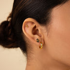 Close-up of a woman's ear with three earrings: a gold hoop, a small stud, and delicate Herkimer Agate Studs.