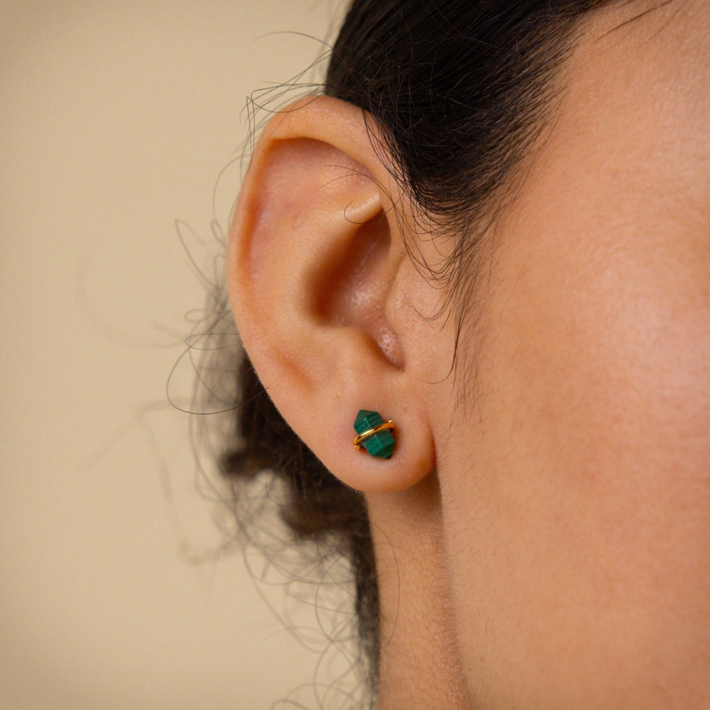 A close up of a woman's ear adorned with Herkimer Malachite Studs.