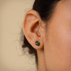 A close up of a woman's ear adorned with Herkimer Malachite Studs.
