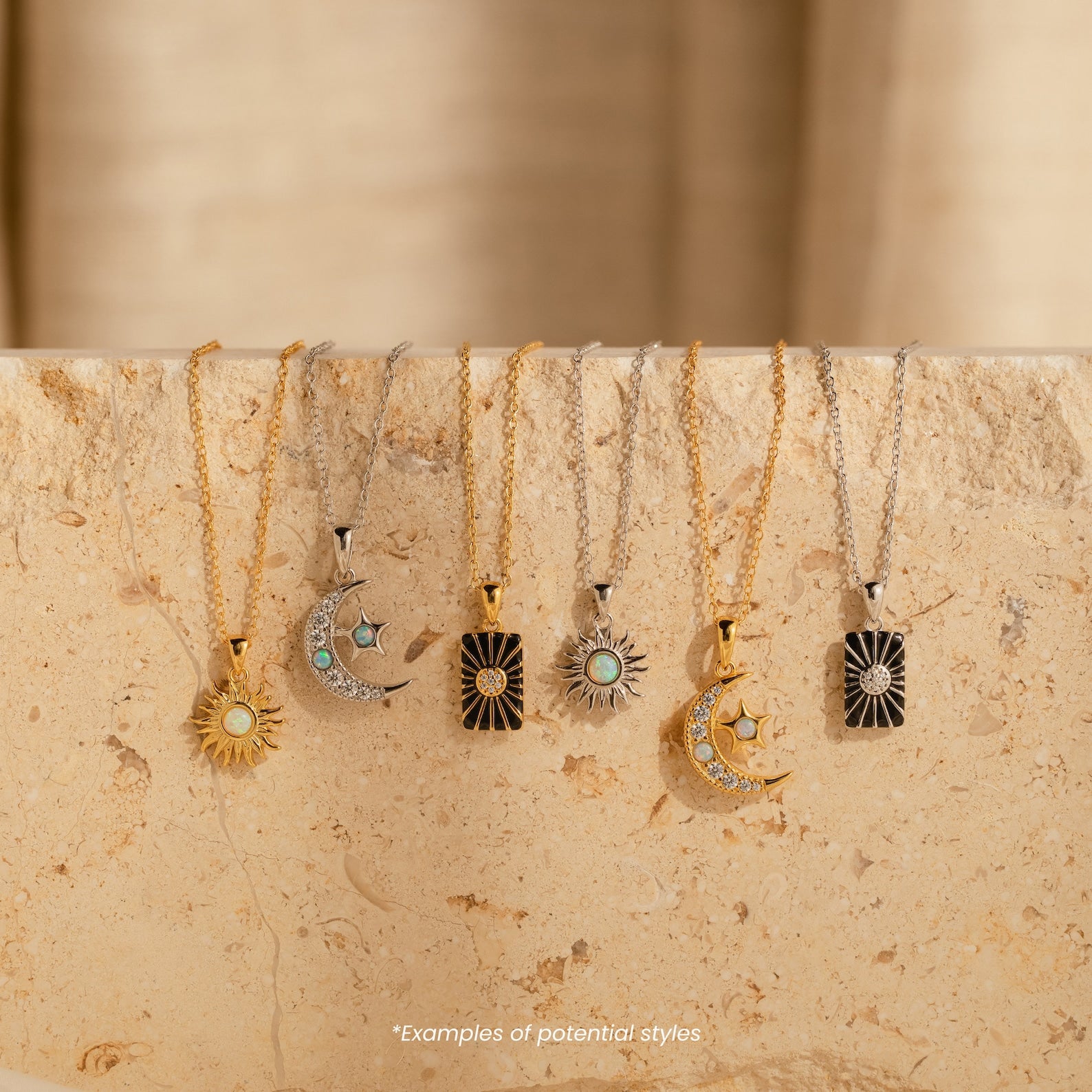 Six Mystery Necklaces with sun and moon pendants are displayed on a beige stone surface, each sophisticated piece capturing a celestial charm.
