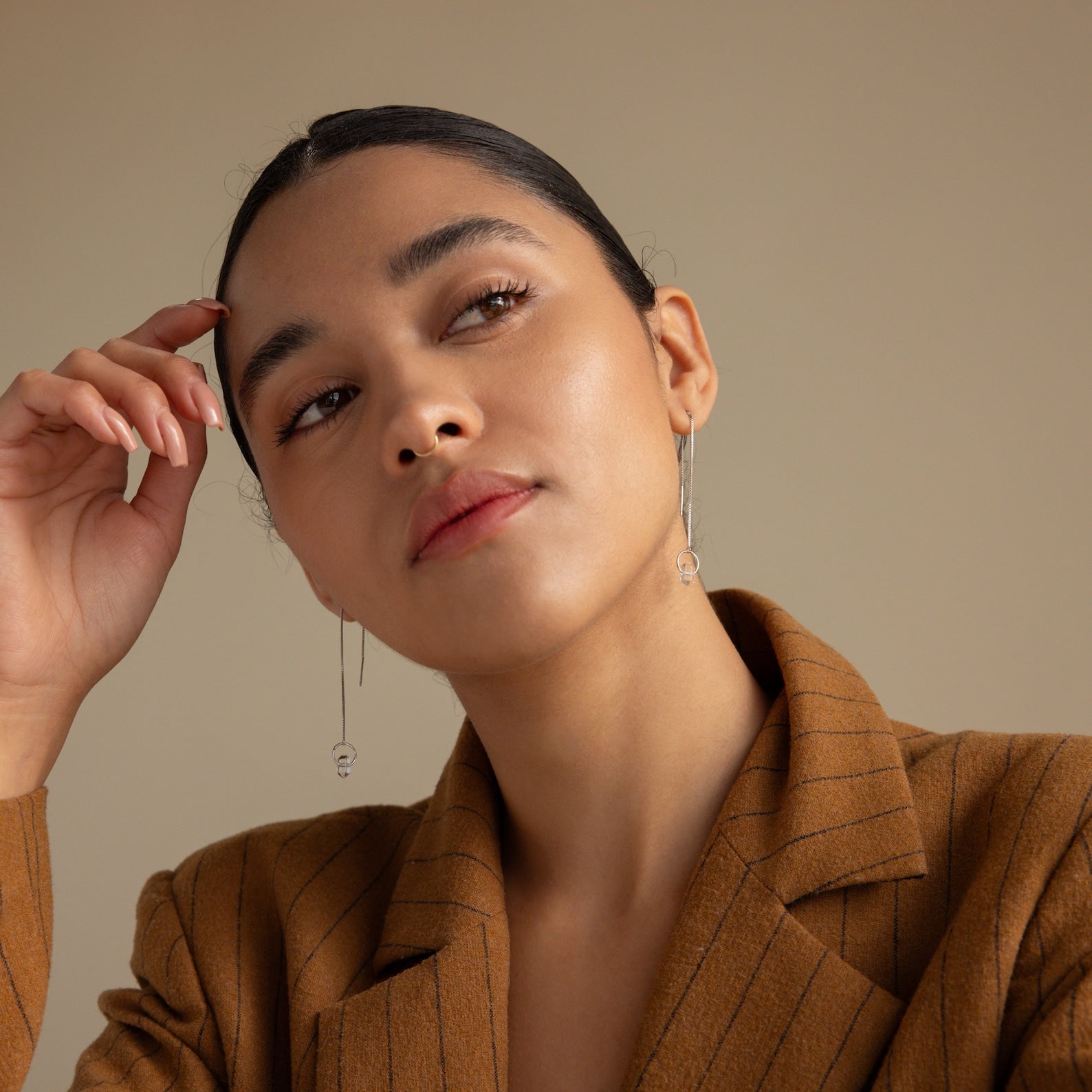 Woman in a brown pinstripe blazer with slicked-back hair, wearing Herkimer Diamond Threader Earrings.