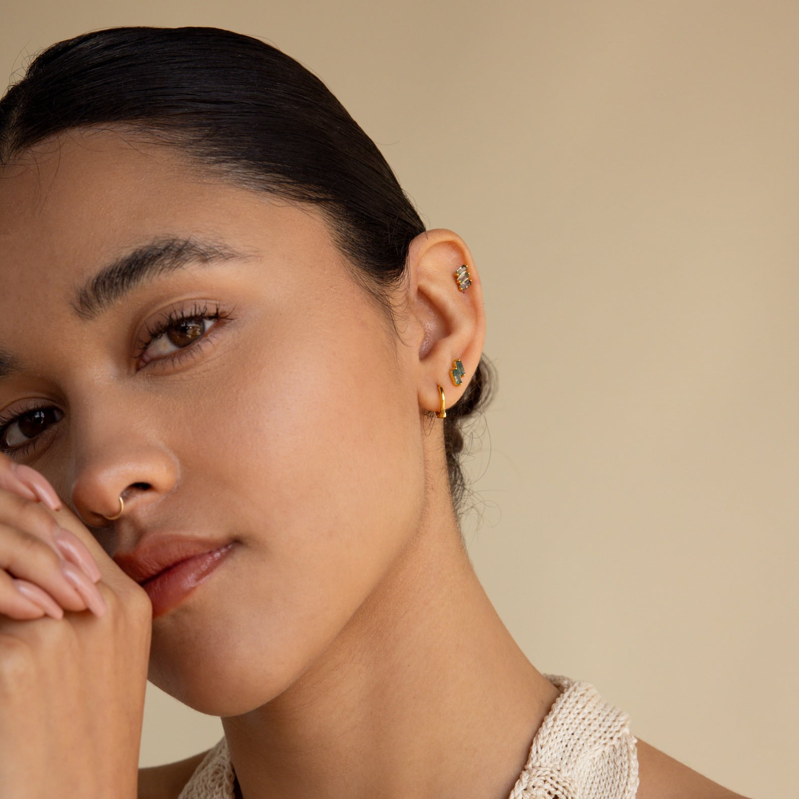 A woman with her hand on her face, showcasing the Agate Cartilage Earrings Set—an elegant gift for best friends who love unique cartilage piercings.