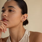 Woman with slicked back hair wearing small hoops and the Agate Cartilage Earrings Set, resting her chin on her hand and looking thoughtful—a stylish choice perfect for cartilage piercings and a unique gift for best friends.