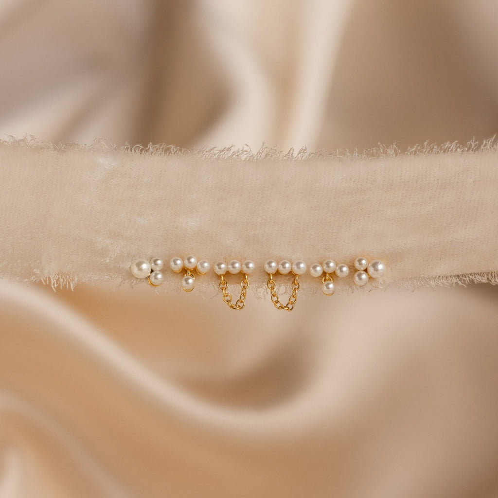 The cream velvet choker features small pearls and gold chain accents, set on satin—perfectly pairs with the Trio Cluster Pearl Studs for an elegant wedding jewelry look.