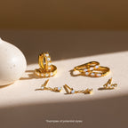 Mystery Earrings from our collection, featuring gold and opal designs in various styles, are displayed on a light surface beside a white vase.