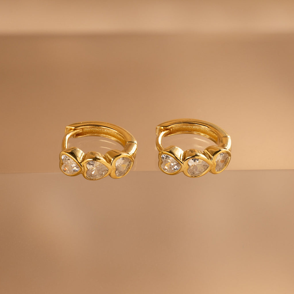 Diamond Bezel Heart Huggies: Gold huggie earrings featuring sparkling diamonds in a delicate heart-cut design.