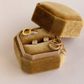 Gold and diamond rings and earrings elegantly displayed in an open Mystery Earrings Box, showcasing timeless beauty and sophistication.