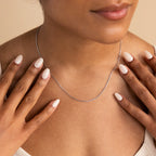 A woman wears the Skinny Mariner Chain Necklace, an ideal choice for everyday style.