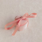 The Pink Velvet Heart Ring Box features a small, heart-shaped coquette design in pink with a matching ribbon bow—ideal as a jewelry case and displayed on a light textured surface.