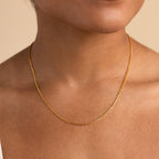 A close-up shows someone wearing the Skinny Mariner Chain Necklace, a delicate piece that's perfect for everyday wear.