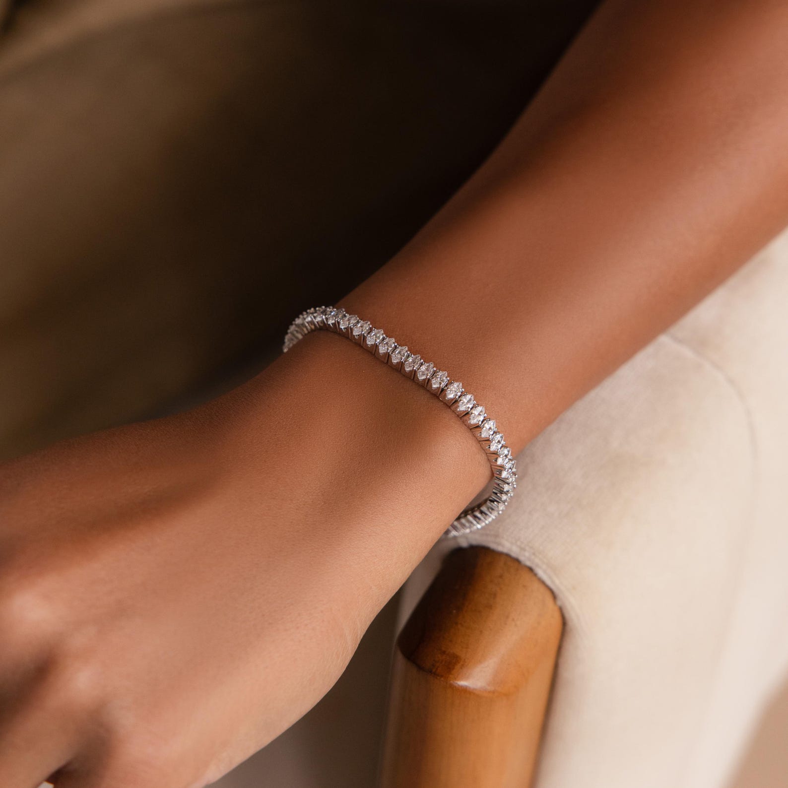 Marquise Diamond Tennis Bracelet in silver worn on a wrist, showcasing its refined sparkle and elegant fit against warm-toned skin.