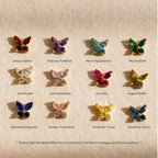 Twelve pairs of Butterfly Birthstone Studs, each symbolizing a birth month, are arranged in rows on a beige background—ideal for fans of gemstone earrings and butterfly jewelry.