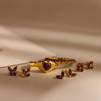 Ivy Flower Birthstone Studs with vibrant red gemstones are displayed on a neutral background with soft shadows.