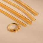 The Ring Size Adjuster includes four coiled, translucent tubes displayed on a beige surface with soft lighting—perfect for anyone needing to tighten loose rings.