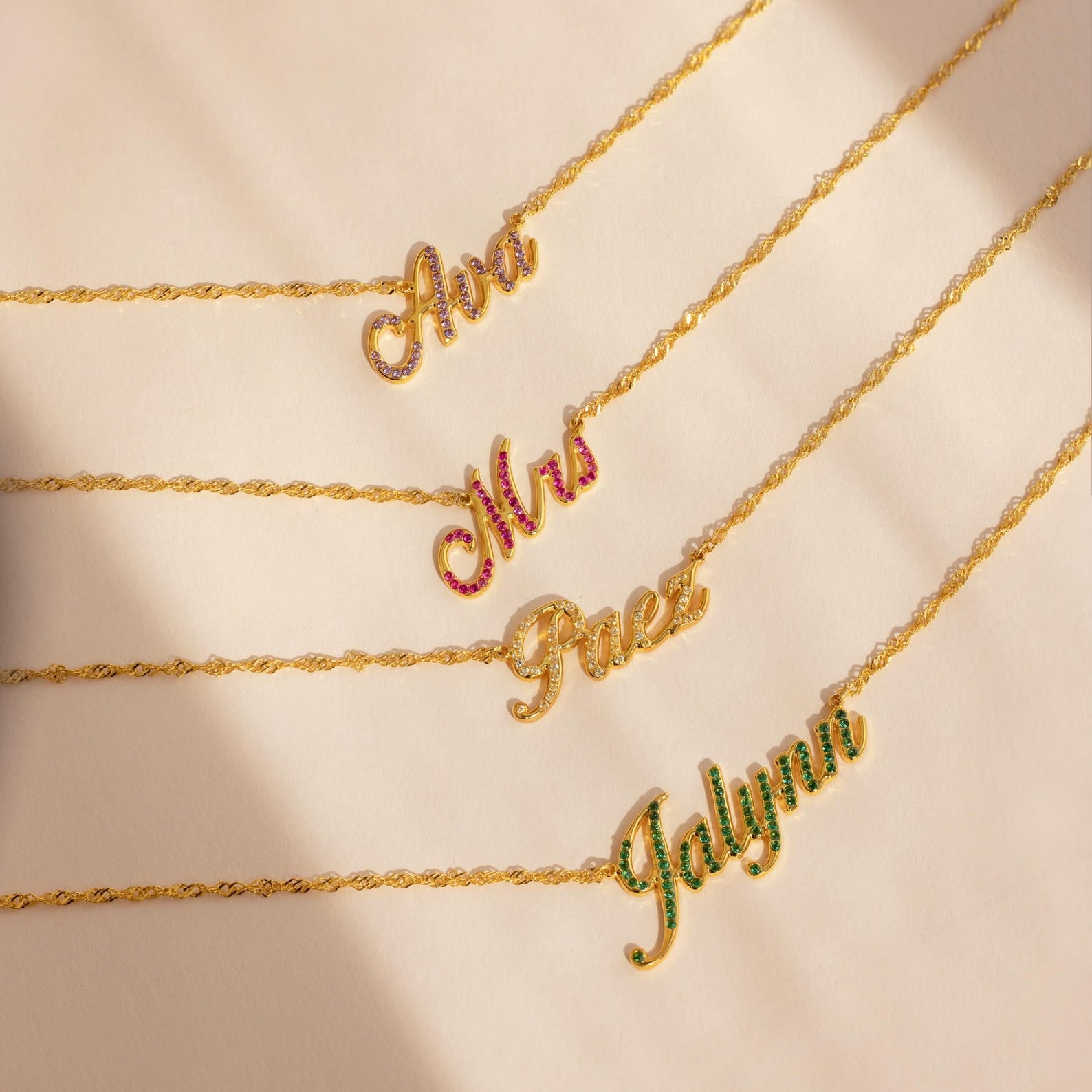 Five Elegant Birthstone Name Necklaces spell Ana, Mrs, Faez, and Jalynn—each accented with a unique gem. This stunning collection is perfect for custom jewelry lovers seeking personalized style.