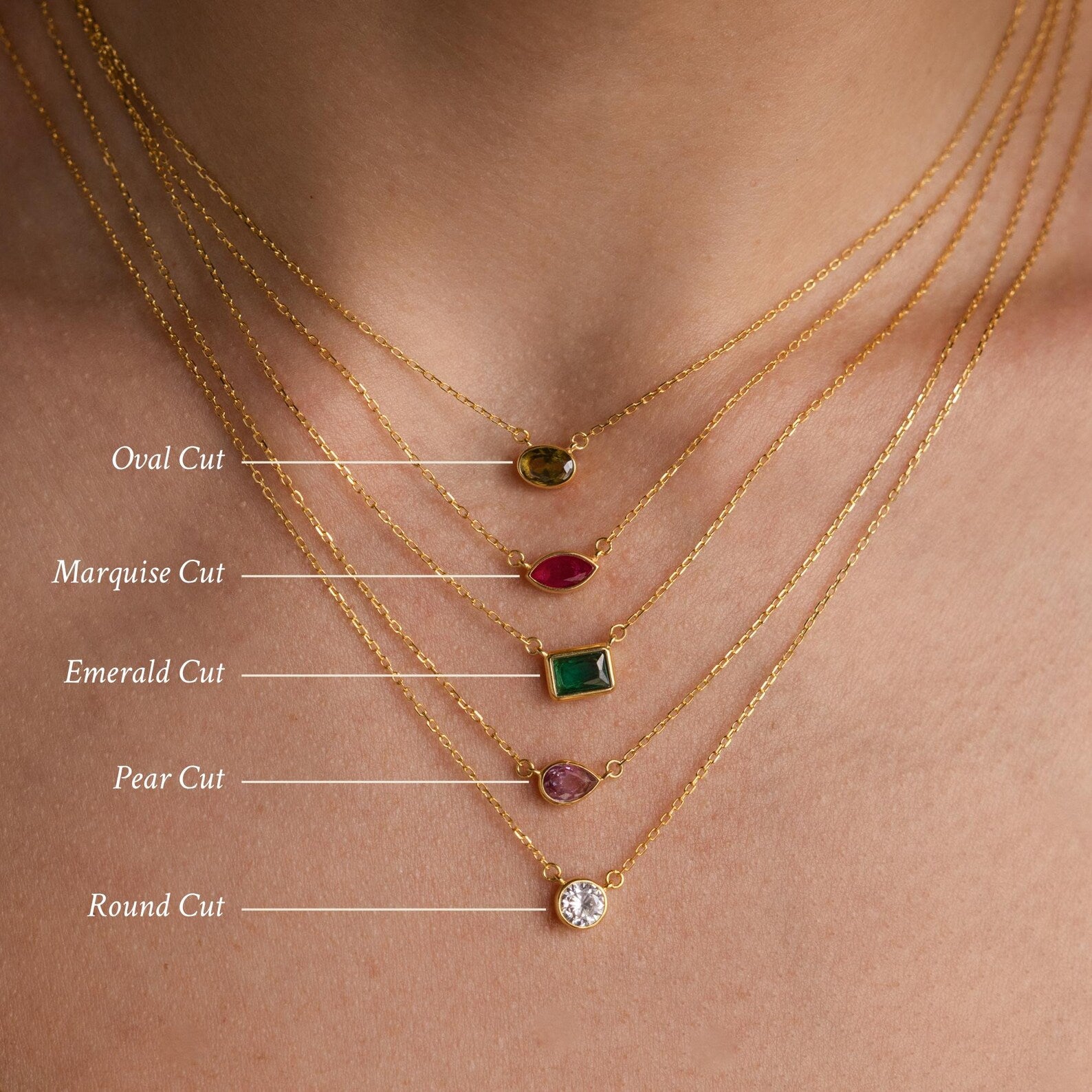 Five Custom Cut Birthstone Necklaces, each featuring a unique gemstone cut—oval, marquise, emerald, pear, and round—highlight the timeless elegance of personalized jewelry.