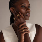 A woman in a white sleeveless top showcases the Multipurpose Mixed Metal Clasp Set on her hands near her face, inspiring chic and elegant accessory layering.