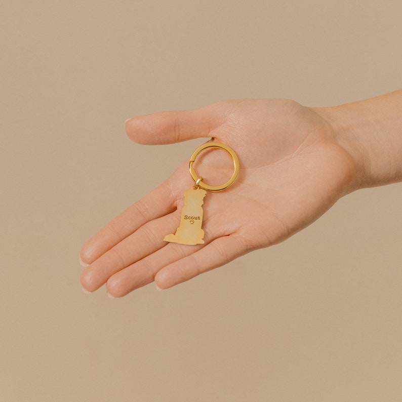 A hand holds a gold keychain with an engraved outline, shown as the Add-On Listing—great for personalization or as a custom order extra.