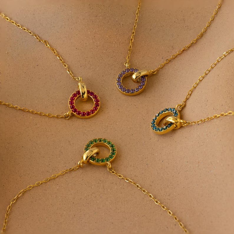 The Interlocking Birthstone Bracelet features colorful, gem-encrusted links—perfect for those who love birthstone jewelry and want to add a personal touch to their style.