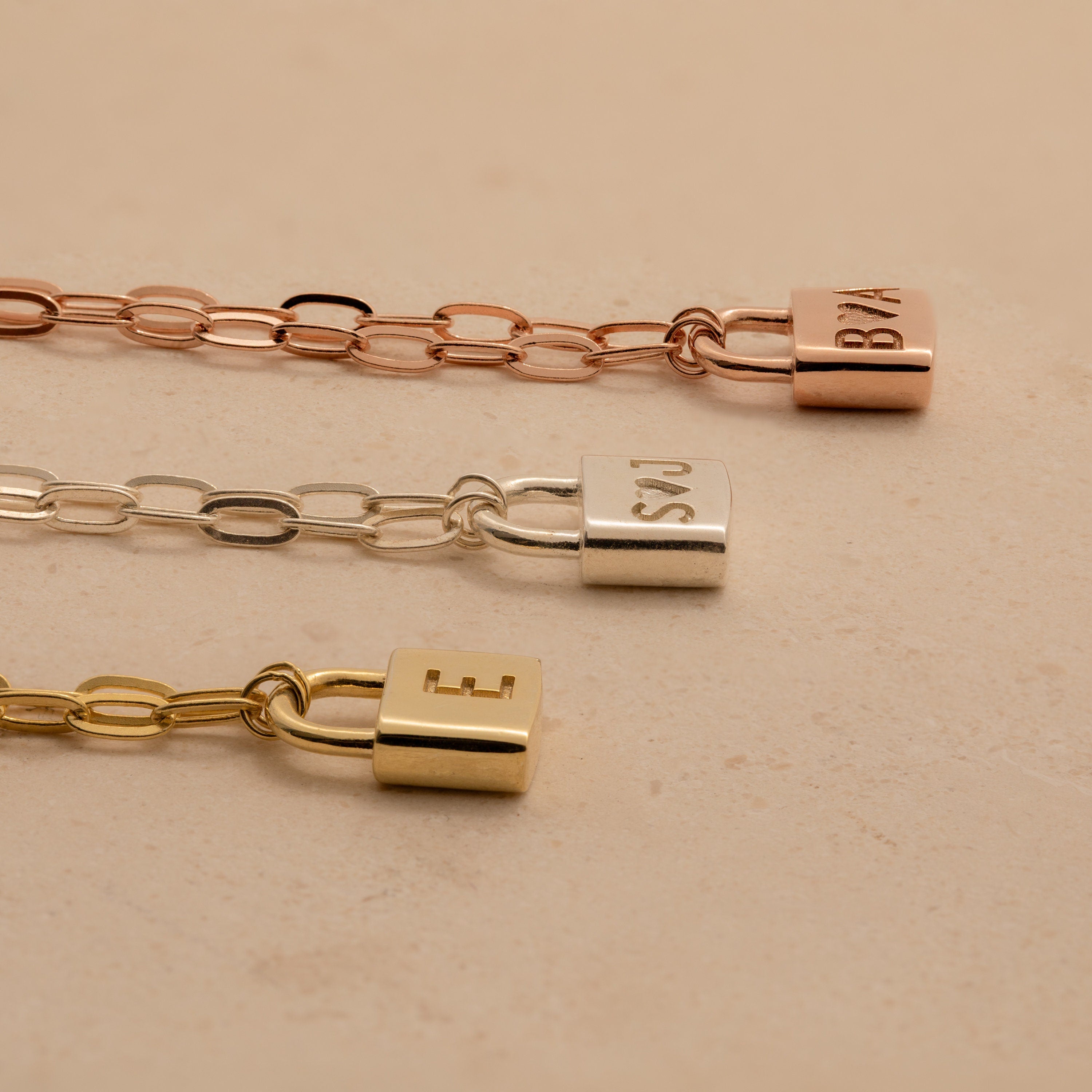 The Initial Padlock Paperclip Necklace features a padlock charm engraved with your chosen letter in rose gold, silver, or gold—perfect for couples or layering with your favorite personalized jewelry.
