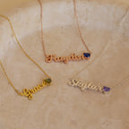 Three Mellow Name Heart Birthstone Necklaces labeled Grace, Hayden, and Skylar, each with a delicate birthstone gem, displayed on a marble surface.