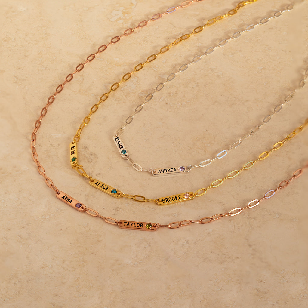 Three Mini Name Birthstone Necklaces, each engraved with a name and accented by a birthstone—a perfect customized gift.