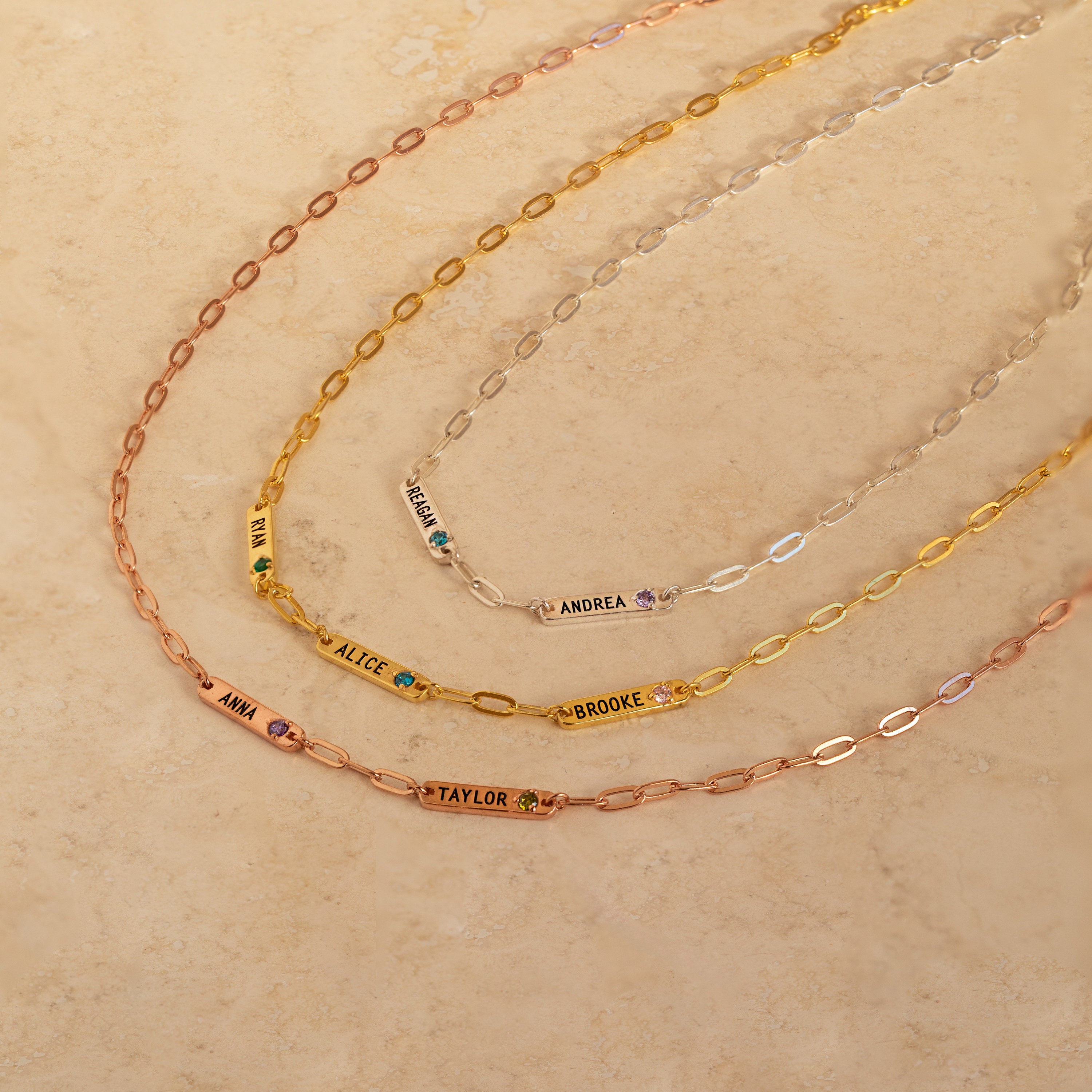 Three Mini Name Birthstone Necklaces, each engraved with a name and accented by a birthstone—a perfect customized gift.