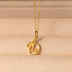 Initial Heart Necklace featuring a cursive letter b pendant on a soft beige textured surface—a beautiful custom piece and the perfect gift for someone you love.