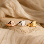 The Lucky Number Signet Rings—engraved with 11, 6, and 13—shine in rose gold, silver, and gold finishes. Each metallic hexagon ring adds a striking statement to any look.
