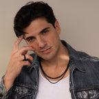 A man in a denim jacket and white shirt poses confidently with his hand near his face, wearing the Men's Black Curb Chain—a standout accessory and an ideal gift for men who appreciate bold style.