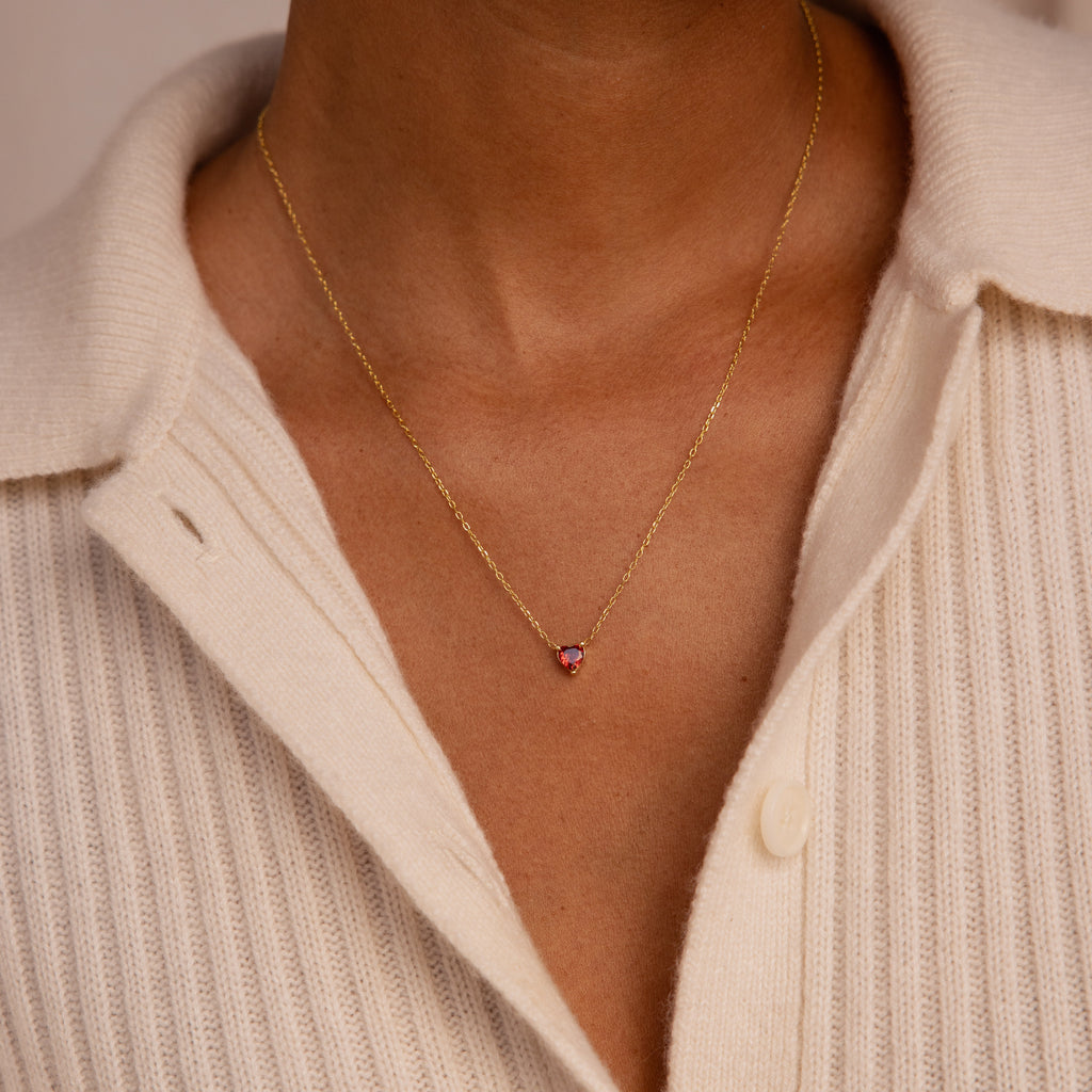 A person wearing the Heart Birthstone Necklace, a personalized jewelry piece perfect as a thoughtful birthday gift.
