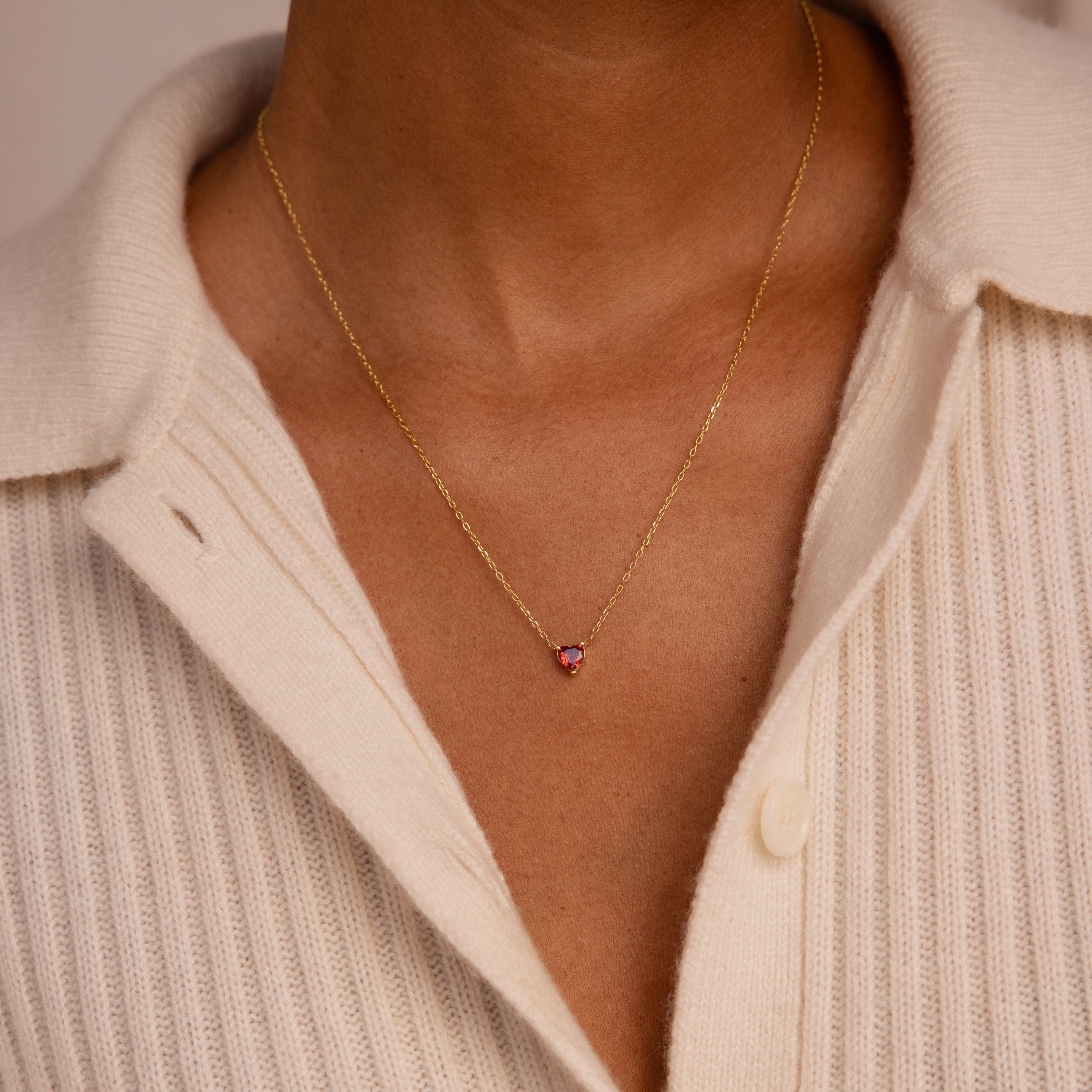 A person wearing the Heart Birthstone Necklace, a personalized jewelry piece perfect as a thoughtful birthday gift.