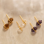 A collection of colorful earrings, featuring stunning quartz crystal pieces and eye-catching Herkimer Smoky Quartz Studs.