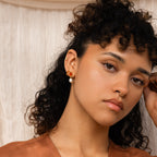 A woman with curly hair wearing the Inside Out Huggies Set.