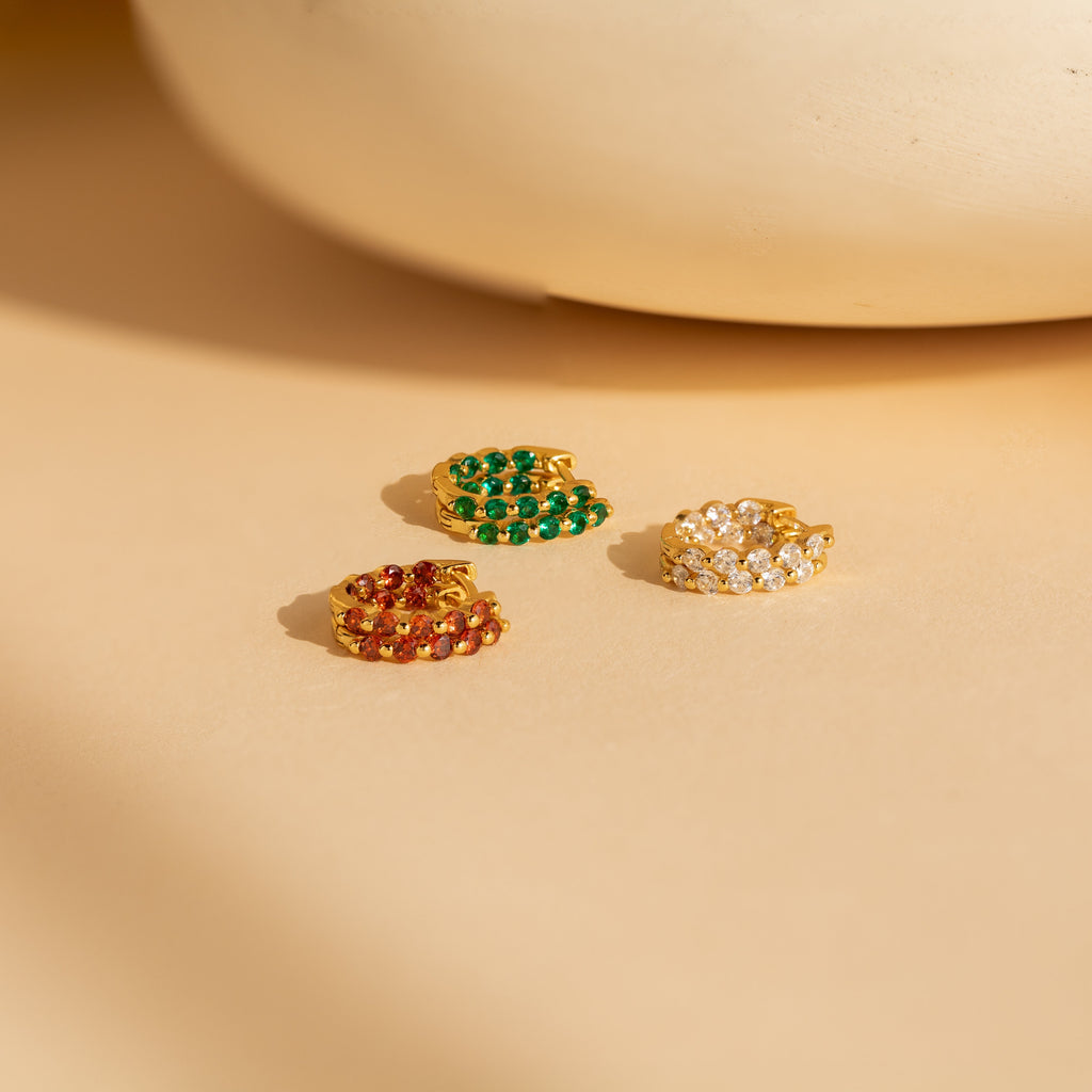 A set of vibrant gemstone hoop earrings called the Inside Out Huggies Set.