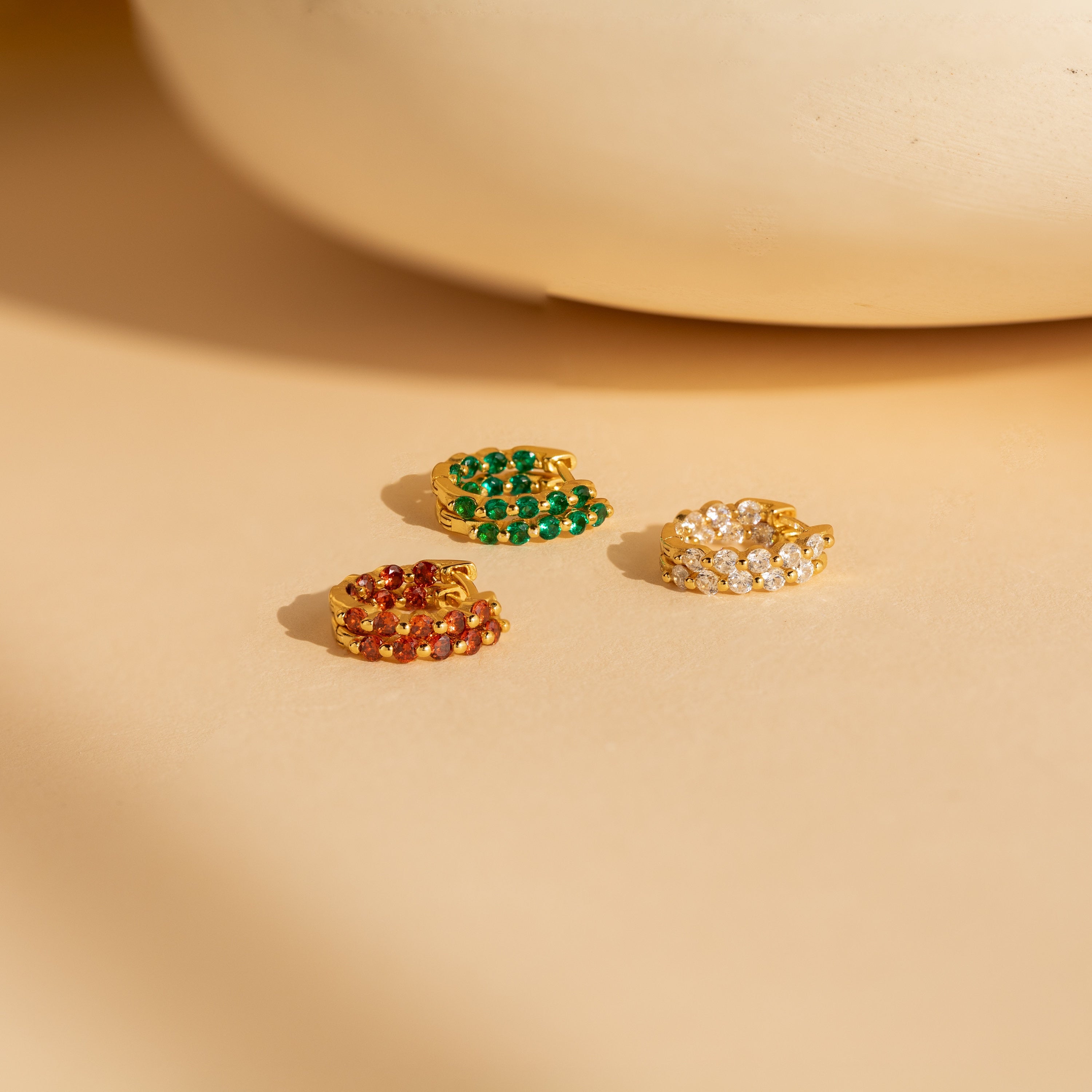 A set of vibrant gemstone hoop earrings called the Inside Out Huggies Set.