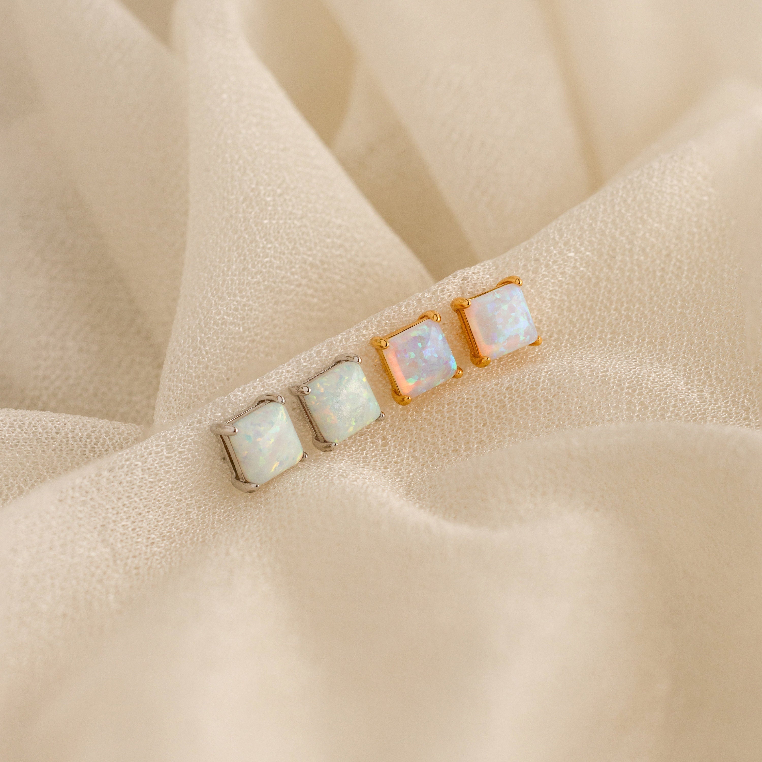 A collection of vintage-inspired white and gold earrings featuring elegant Princess Cut Opal Studs and opal designs.