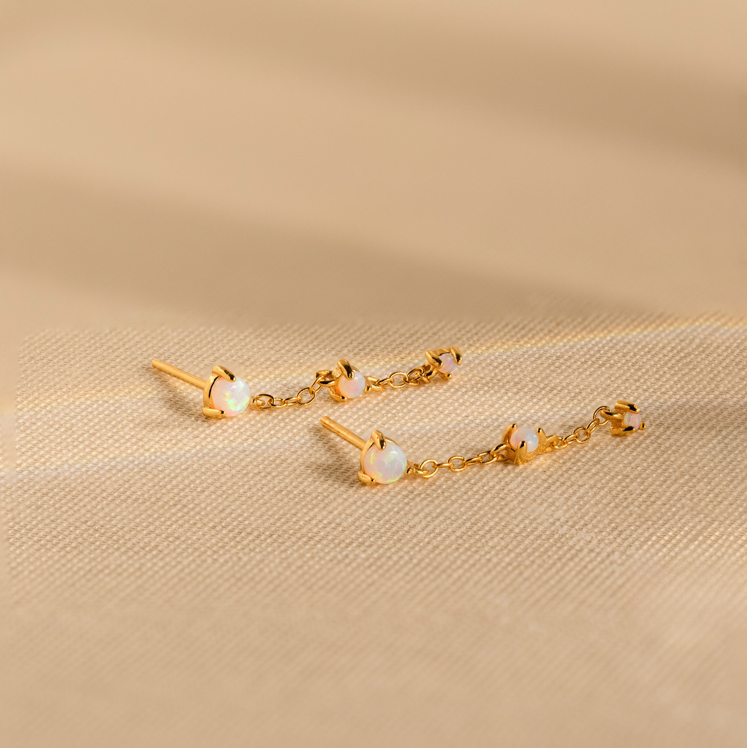 Opal Chain Drop Earrings feature gold and white stones—ideal for elegant bridesmaid jewelry or adding a subtle statement to any outfit.