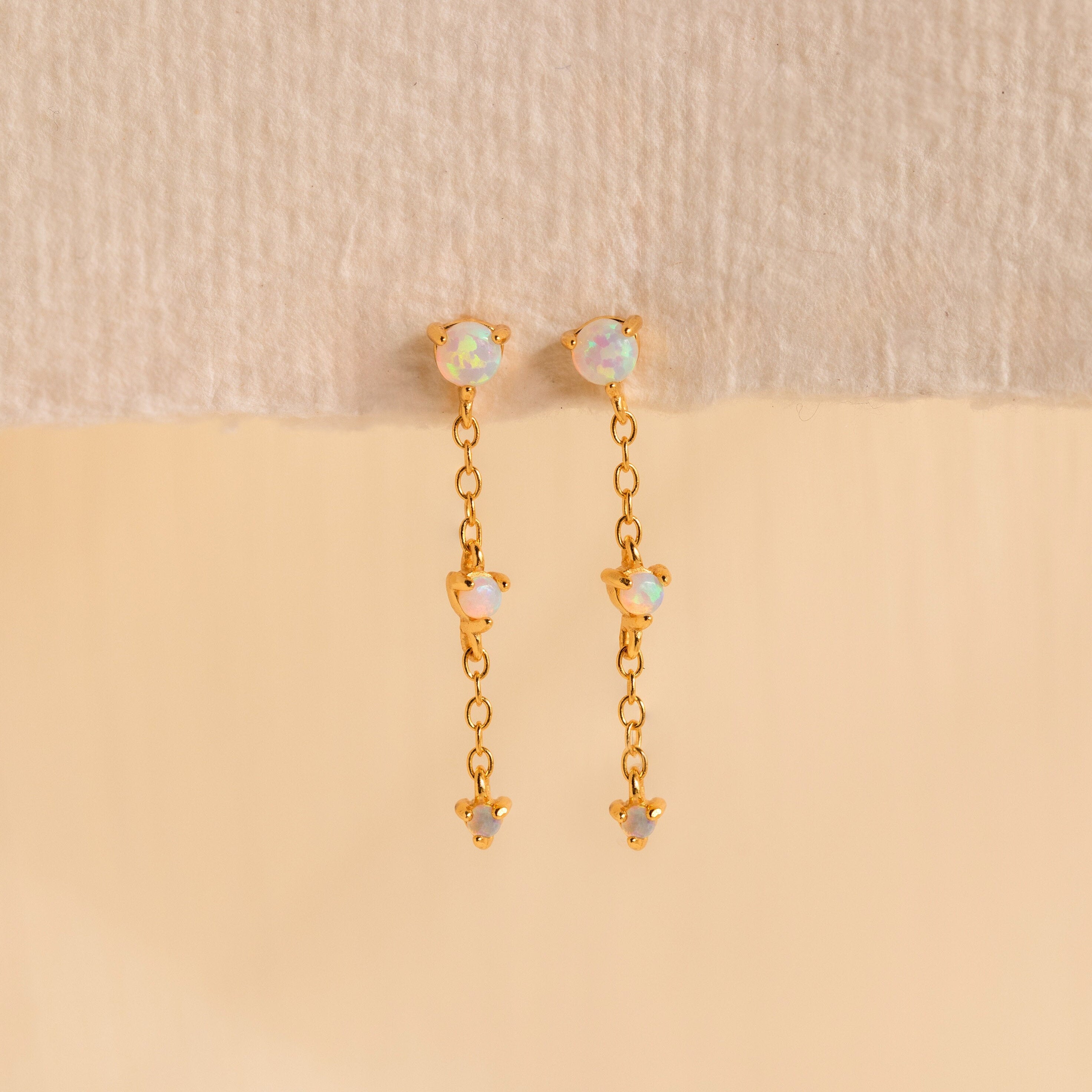 Dainty Opal Stud Earrings Set displayed against a neutral beige background—ideal for fans of minimalist jewelry and elegant opal stud earrings.