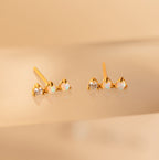 Opal Diamond Bar Studs are displayed on a soft beige surface, showcasing their elegant design with opal and diamond-like stones—perfect earrings for any occasion.