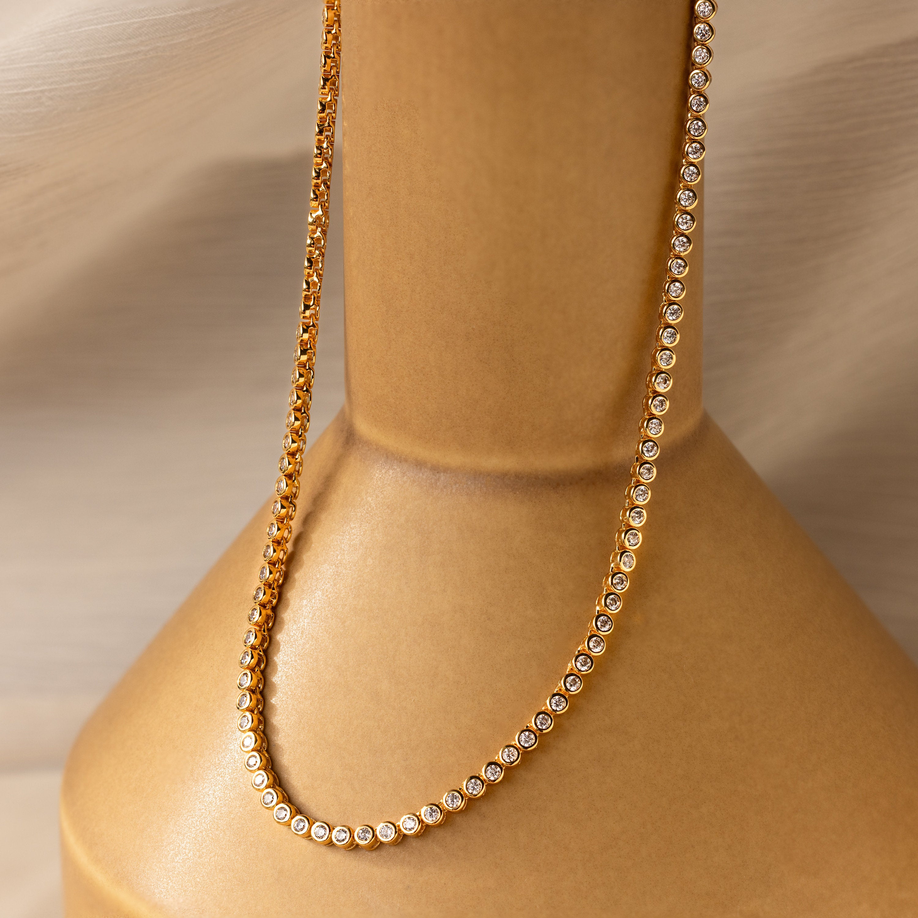 The Diamond Bezel Tennis Necklace with small round diamonds shines elegantly—a stunning bridal necklace and perfect gift for the bride.