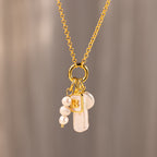 The Long Baroque Pearl Charm in 18K Gold features a gold chain, a Baroque pearl charm, and a gold square pendant with the letter B—a stunning addition to your pearl jewelry collection.