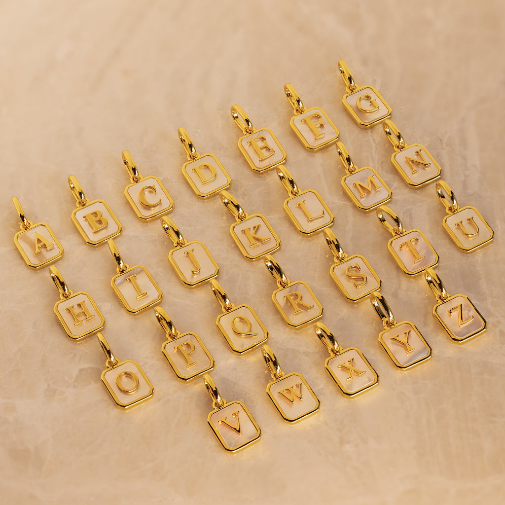 26 gold mother of pearl initial charms in letters A through Z
