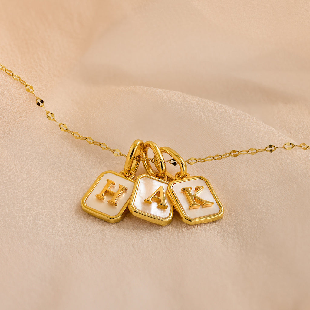 Mirror chain necklace with 3 gold mother of pearl initial charms in letters H, A, K