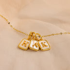 Mirror chain necklace with 3 gold mother of pearl initial charms in letters H, A, K